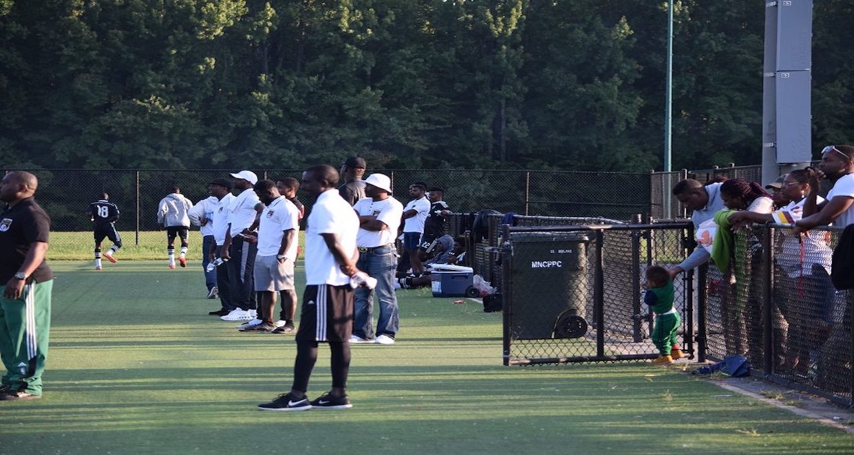 Players, supporters and families sharing the sideline at an NSL game